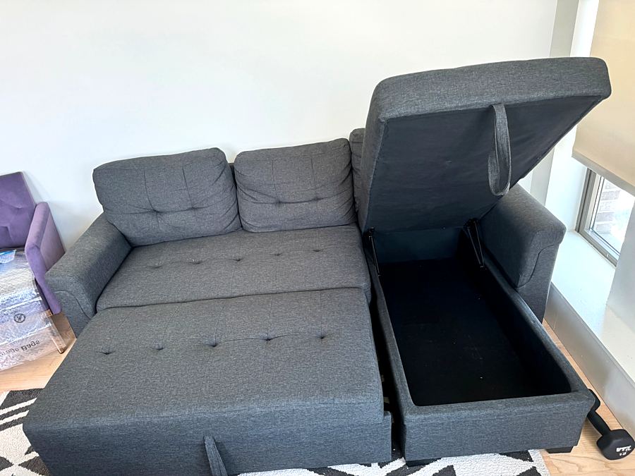 Assembled gray sectional sofa bed with the storage chaise open