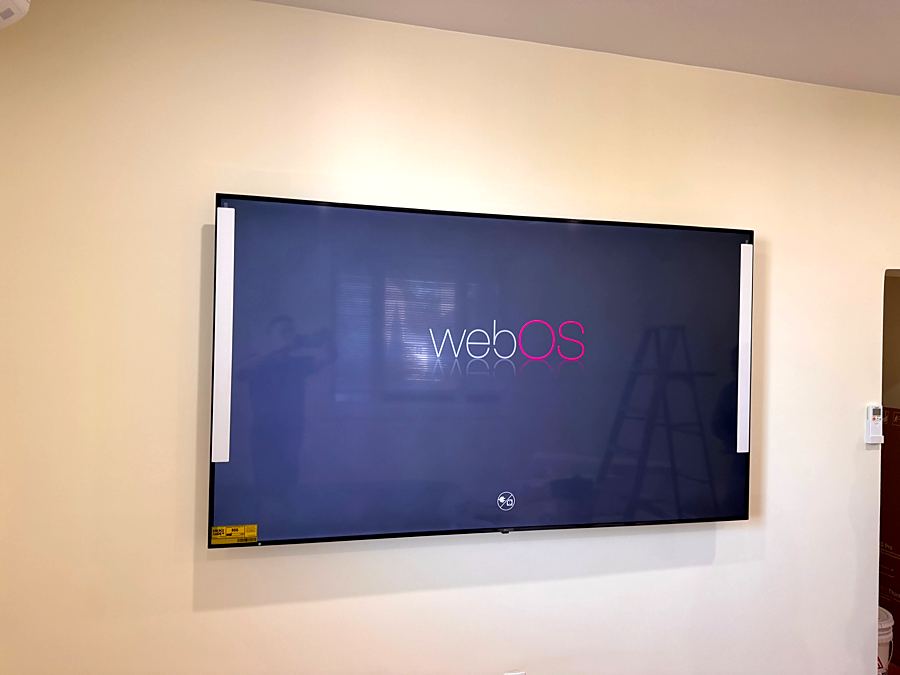 Large TV mounted flat on a cream wall